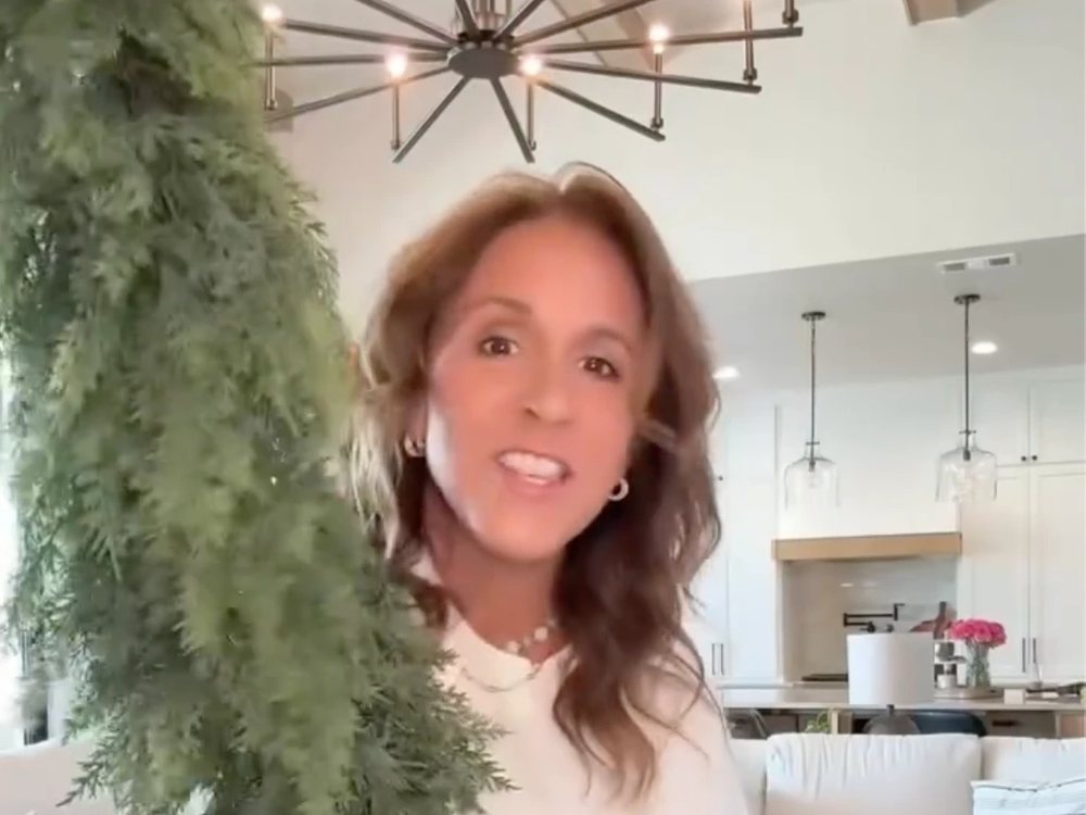 Customer holding the garland in her living room